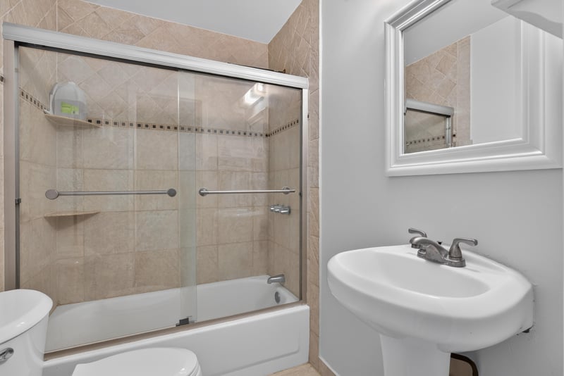 Bathroom with tub-shower combination and pedestal sink at 5745 110th St, Jacksonville, FL 32244