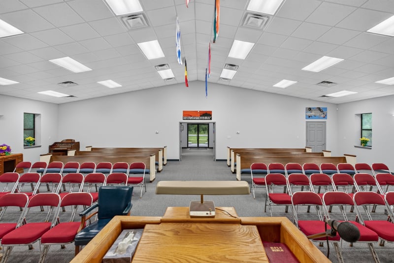 Assembly hall view from stage toward pews at 1038 County Rd 315, Melrose