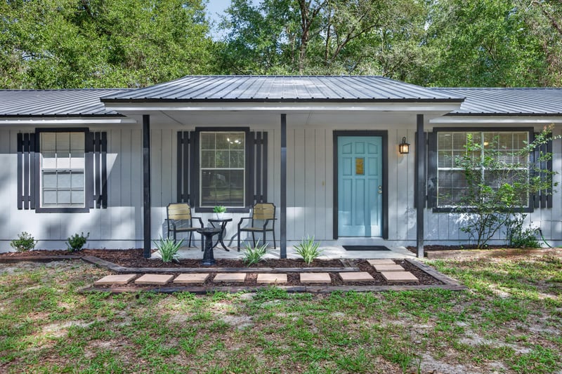 Front porch with seating and teal front door at 2829 Blackberry Ave