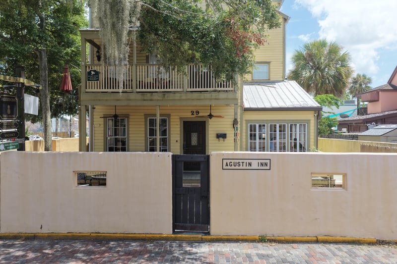 Building entrance with black door and wall-mounted sign at 29 Cuna St, St. Augustine, FL 32084