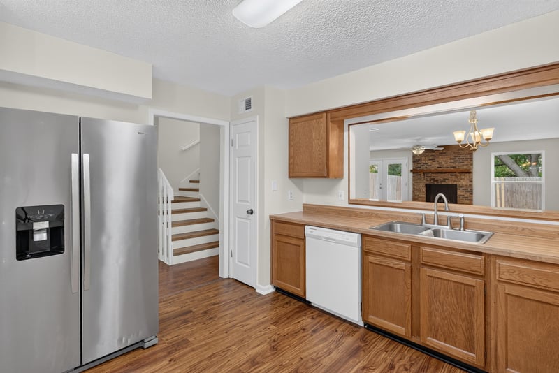 Kitchen with stainless refrigerator and stairway at 4427 Millstone Ct, Jacksonville, FL