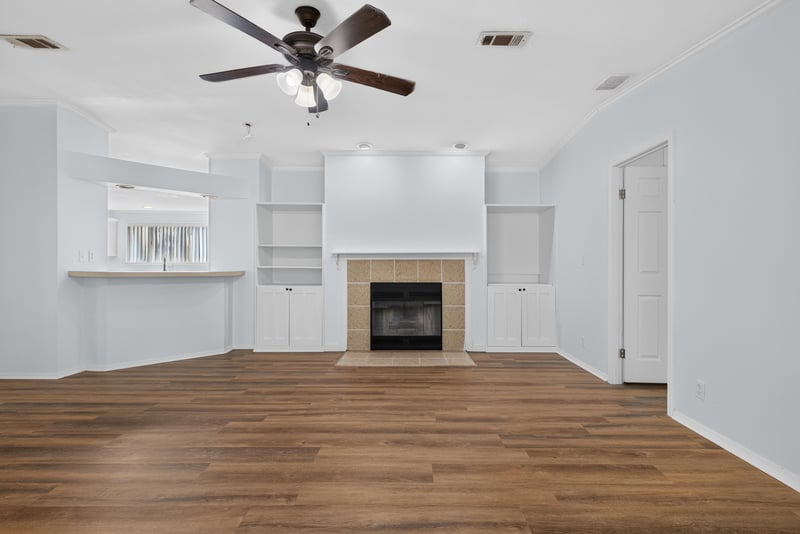 Living room with built-in shelving around fireplace at 3215 Robin Ln, Middleburg, FL