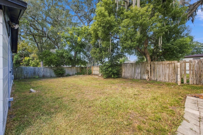 Backyard with grass and fencing at 417 Capricorn Ln, Orange Park, FL 32073