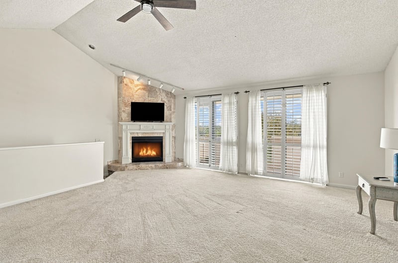 Empty living room with fireplace and carpet at 752 Spinnakers Reach Dr, Ponte Vedra Beach, FL 32082