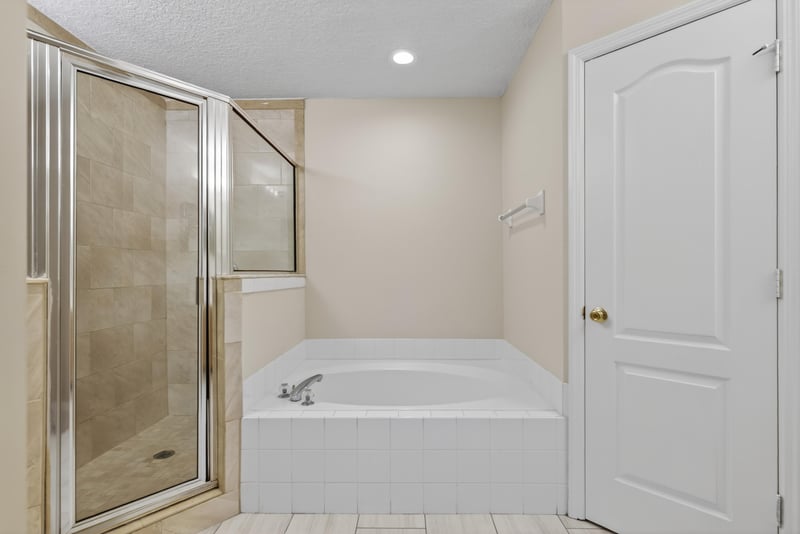 Bathroom with glass shower and tub at 1648 Glen Laurel Dr, Middleburg, FL 32068