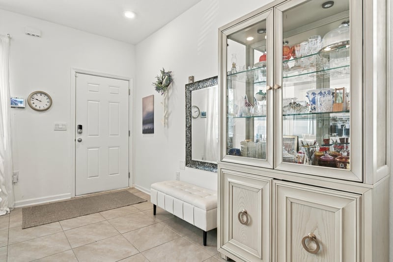 Entryway with front door and glass-front hutch at 8359 Zenith Cir, Jacksonville, FL 32256