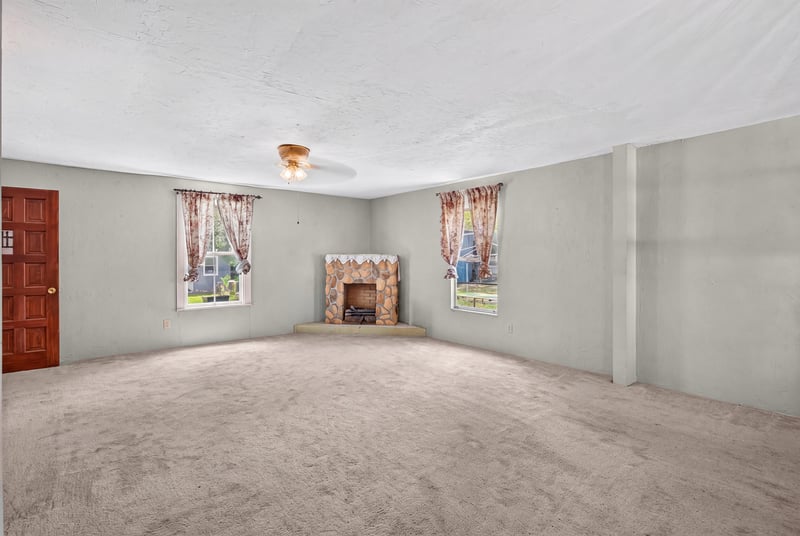 Unfurnished room with fireplace and window at 1173 US-17, Satsuma, FL 32189