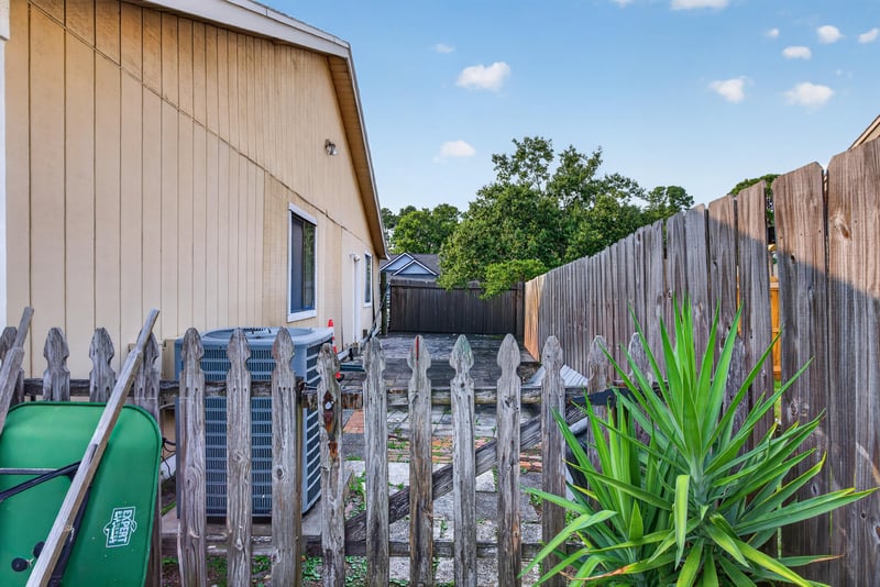 Side yard with trash bins and fence at 13020 Medford Ln, Jacksonville, FL 32225
