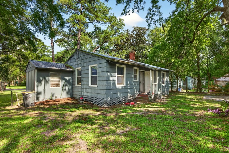 Front exterior with gray siding and lawn at 2132 Allandale Cir W, Jacksonville, FL