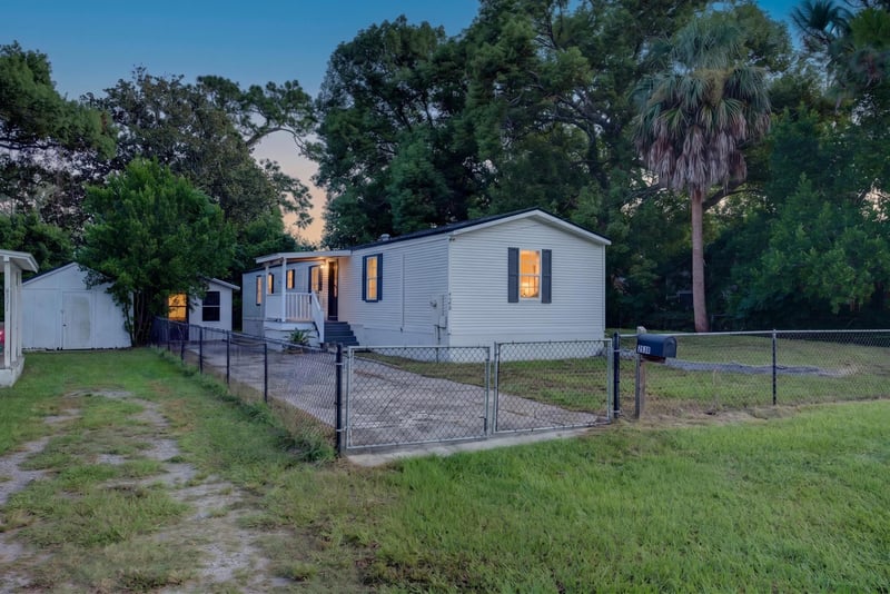 Front exterior at day-to-dusk with porch light on at 4565 Appleton Ave, Jacksonville, FL