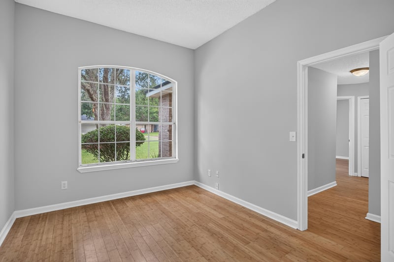 Bedroom with wood floors and window at 456 Bay Point Way N, Jacksonville, FL 32259