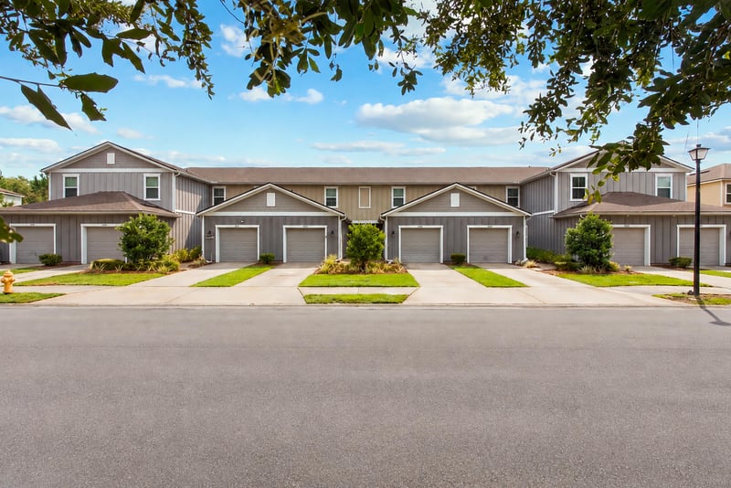 Daytime front view of the townhome row from the street at 9555 Star Dr, Jacksonville, FL 32256