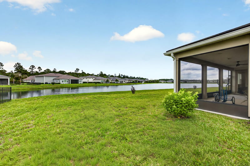 Backyard with pond view and screened porch at 85491 Fall River Pkwy, Fernandina Beach, FL 32034