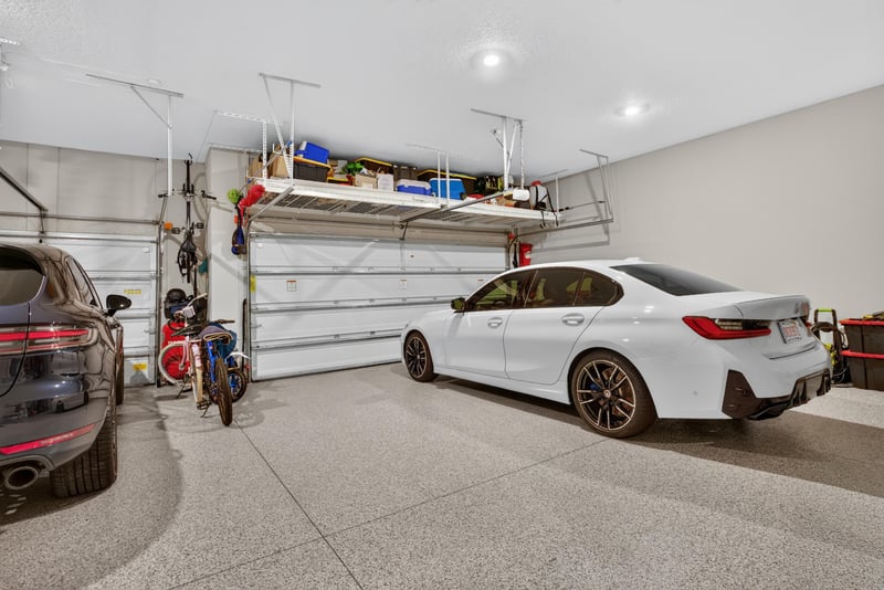 Garage with car and storage shelving at 22 Azura Point