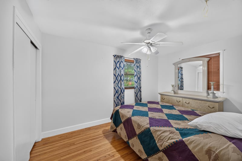 Bedroom with dresser and patterned curtains at 1847 Grove Park Dr, Orange Park, FL