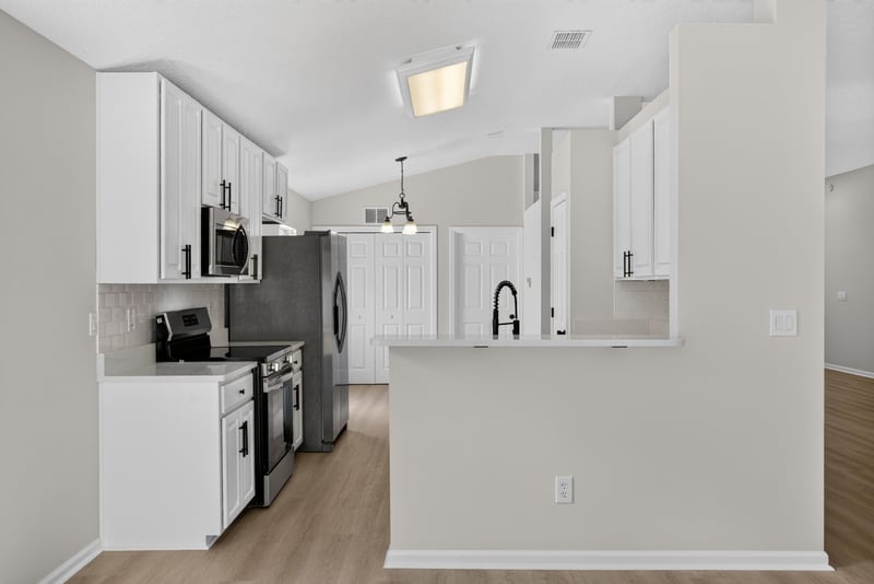 Kitchen with black appliances and white cabinets at 224 Pine Arbor Cir, St. Augustine, FL 32084