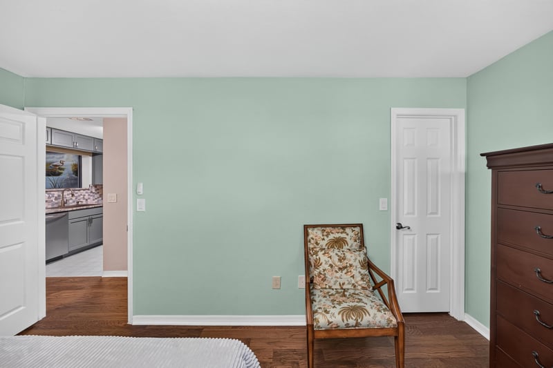Bedroom area with closet and upholstered chair at 10150 Belle Rive Blvd, Jacksonville, FL