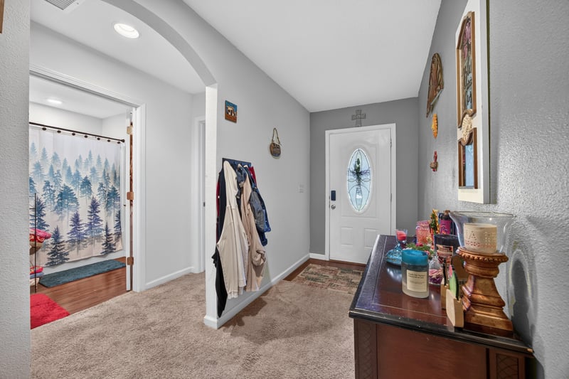 Entry hallway with stained-glass door and console table at 518 Matecumbe Ct, Macclenny, FL