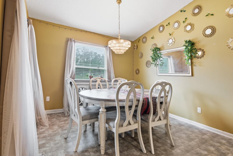 Dining area with table and chandelier at 7392 Timber Falls Ct