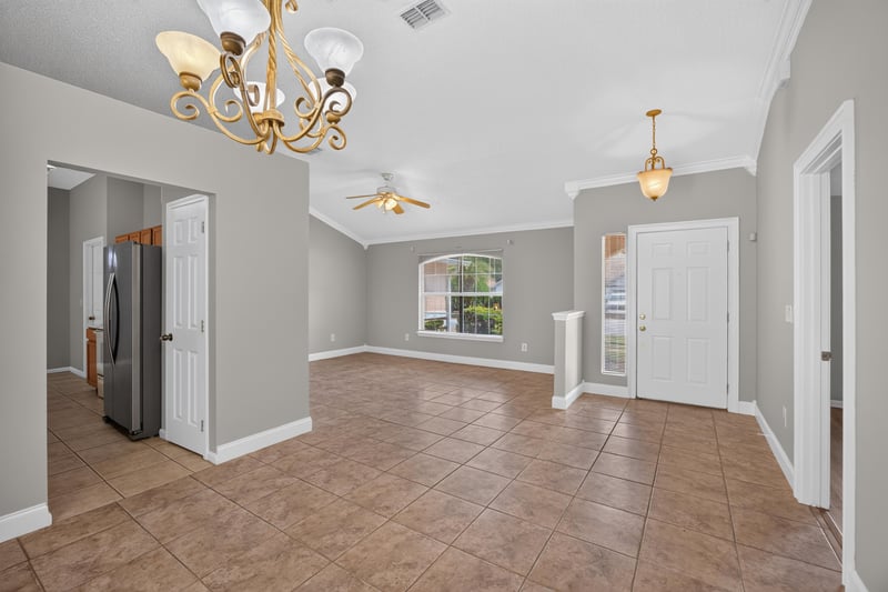 Entry hallway with tile floor and chandelier at 9256 Dale View Ln W, Jacksonville, FL 32225
