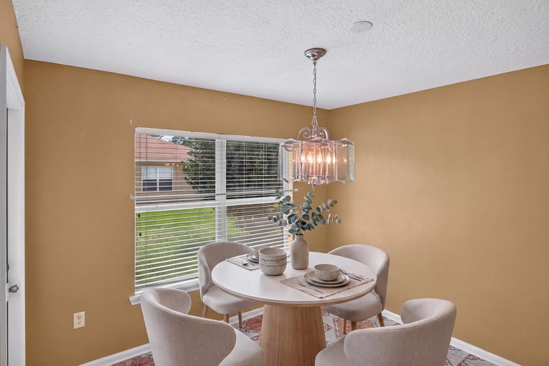 Virtually staged breakfast nook with round table at 2282 Justin Lake Dr, Jacksonville, FL