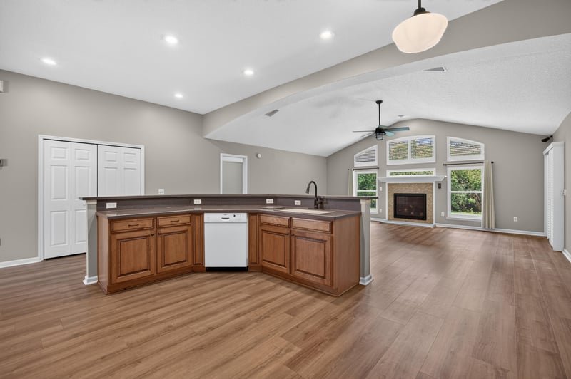 Open kitchen and living area with vaulted ceiling at 1955 GUARDED Way, Fleming Island, FL 32003