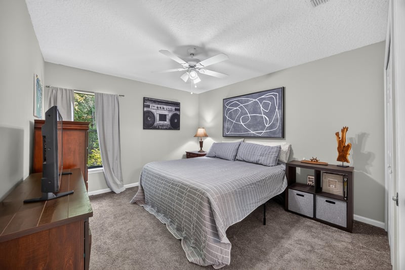 Bedroom with carpet and wall-mounted TV at 2125 Blue Heron Cove Dr, Orange Park, FL 32003