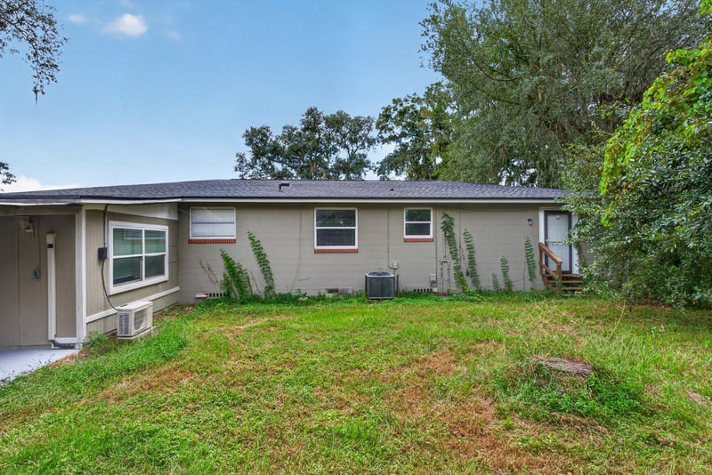 Rear exterior and open backyard at 217 Baisden Rd, Jacksonville, FL 32218