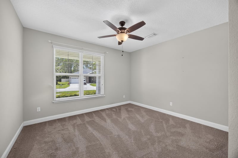 Carpeted bedroom with window and ceiling fan at 53 Lumen Ct, St. Augustine, FL 32095