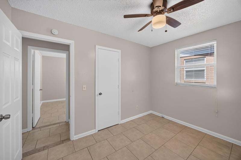 Bedroom with closet doors and window at 8067 Parental Cir, Jacksonville, FL 32216