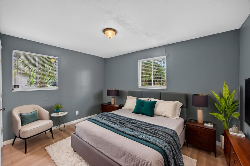 Bedroom virtually staged with bed and accent chair at 6745 Jack Horner Ln, Jacksonville, FL 32210