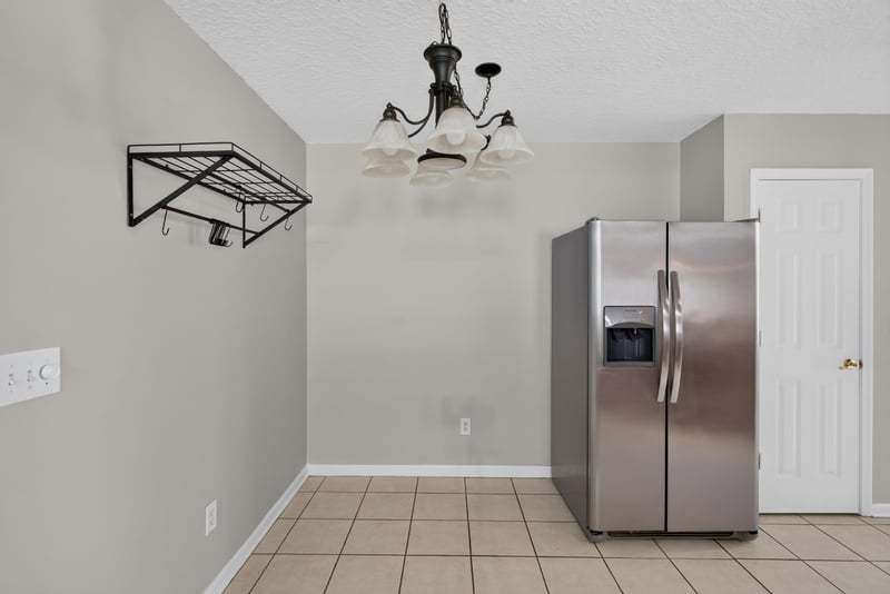 Kitchen nook with pendant light and stainless refrigerator at 11669 Collins Creek Dr, Jacksonville, FL 32258
