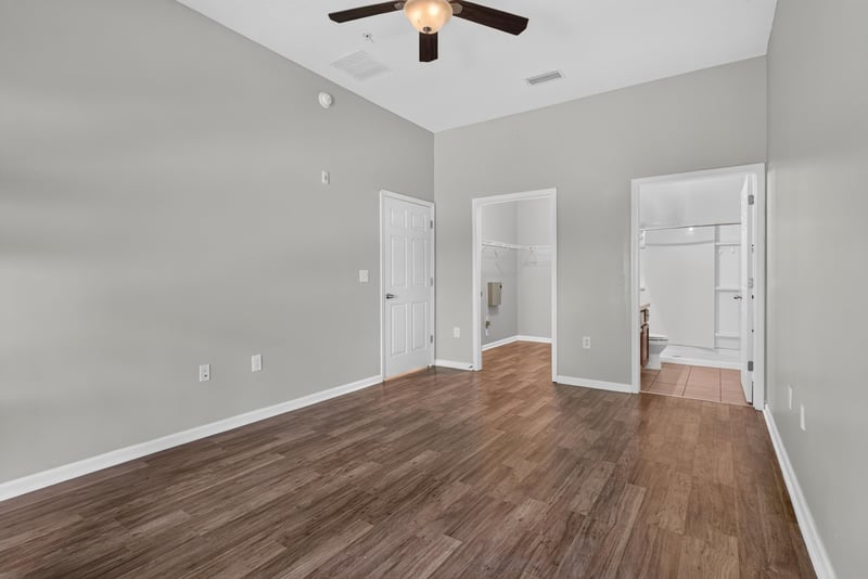 Bedroom with ceiling fan and hallway view at 8196 Cabin Lake Cir, Jacksonville, FL 32256