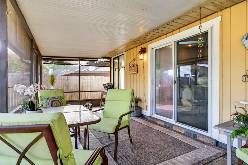Screened porch with sliding door and patio furniture at 13020 Medford Ln, Jacksonville, FL 32225