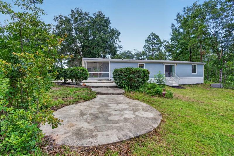 Front exterior view with walkway and landscaping at 4890 McAllister Rd, Middleburg, FL 32068