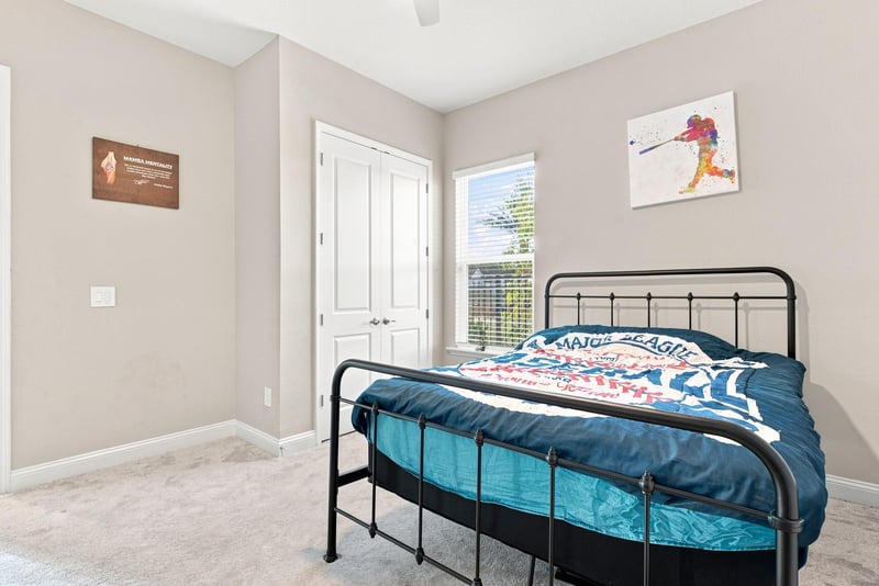 Bedroom with metal bed frame and closet door at 27 Holly Rdg Wy, St. Augustine, FL