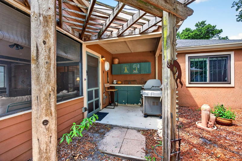 Screened patio with grill and pergola at 4837 Pareja Ct, Jacksonville, FL 32225
