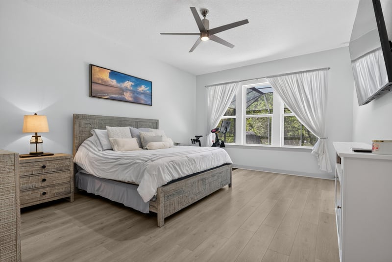 Bedroom with ceiling fan and wall-mounted TV at 785 Back Creek Dr, St. Augustine, FL 32092