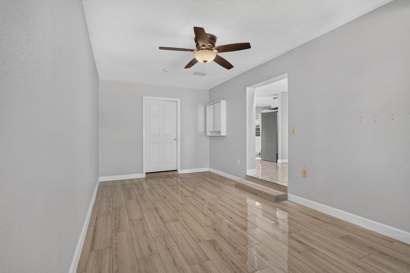 Living area with wood-look flooring and ceiling fan at 442 Ameca Ave, Orange Park, FL 32073