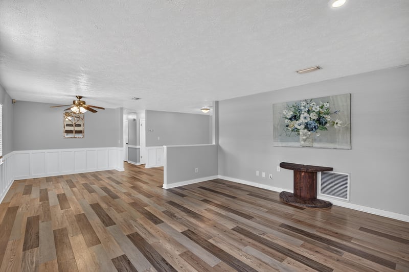 Living room opening into dining area with ceiling fan at 6757 Deer Springs Rd, Keystone Heights, FL 32656