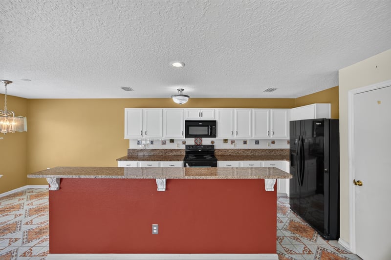 Kitchen island close-up with pendant lighting at 2282 Justin Lake Dr, Jacksonville, FL