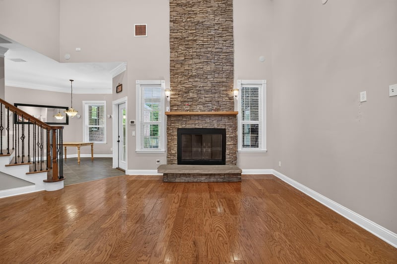 Great room fireplace with stacked stone surround at 1735 Hagans Ridge Ct