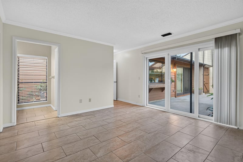 Living room with sliding glass doors to back patio at 3515 Cormorant Branch Ct, Jacksonville, FL