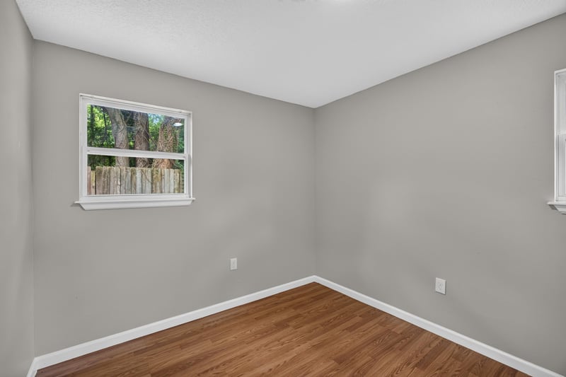 Empty bedroom with window at 7015 Miss Muffet Ln N, Jacksonville, FL 32210