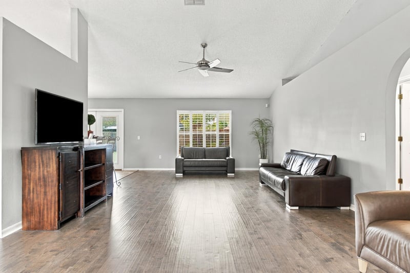 Great room with TV and wood floors at 11197 Illford Dr