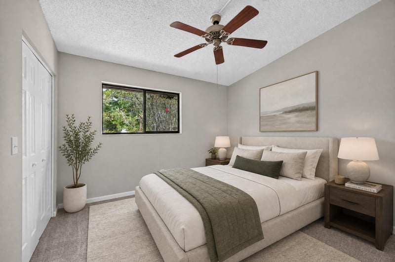 Virtually staged bedroom with plant and artwork at 3801 Crown Point Rd, Jacksonville, FL 32257