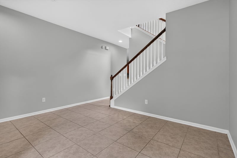 Staircase with wood railing at 13685 Goodson Pl, Jacksonville, FL 32226