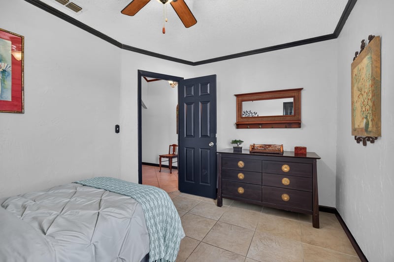 Bedroom with twin bed and dresser at 6931 Cane Grass Ln E, Jacksonville, FL 32244