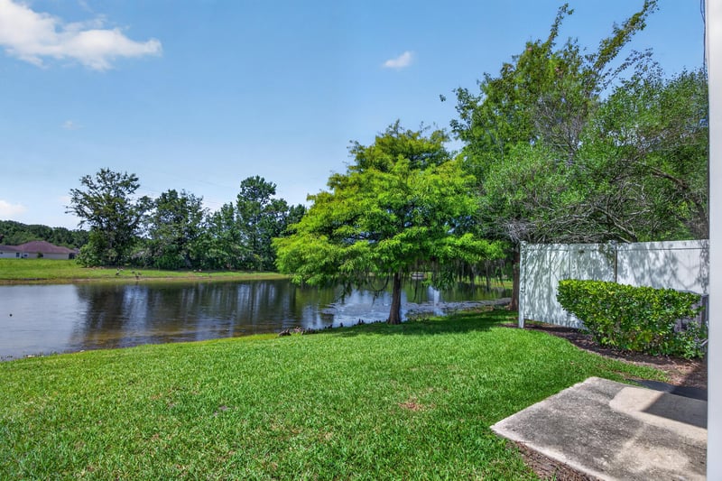 Backyard view of pond and lawn at 1572 Biscayne Bay Dr, Jacksonville, FL 32218