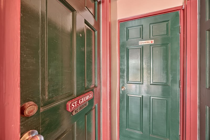 Green guest room door with a St. George nameplate at 115 Cordova St, St. Augustine, FL